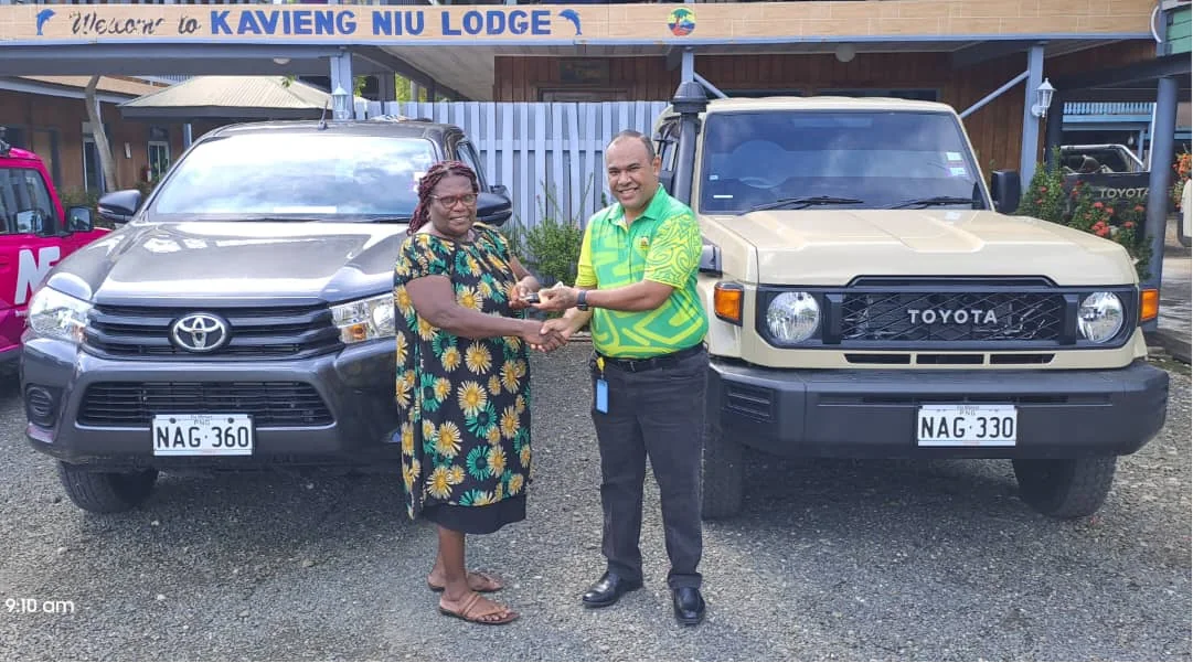 NDB's David Munaga presents Star Wheels owner Getruth Merebo with the keys to her new NDB-financed vehicles in Kavieng